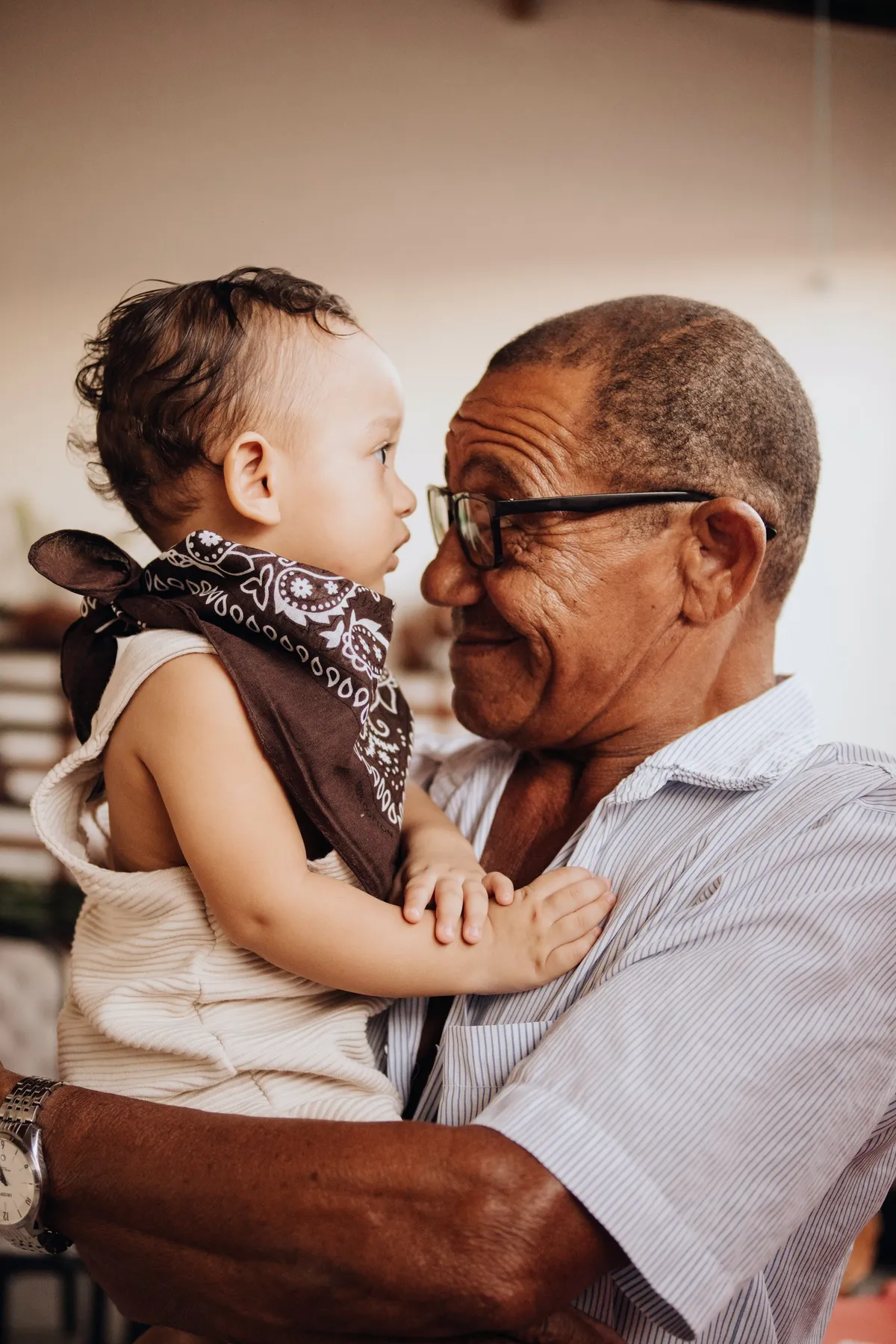 A grandfather holding his grandchild close